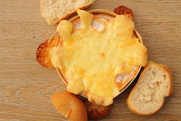 an oven-baked camembert with bread rolls