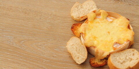 an oven-baked camembert with bread rolls