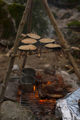 Cooking vegetables in the open air. Camping in the nature. Smoked vegetables.
