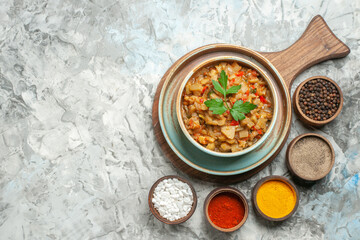 top view roasted eggplant salad in bowl different spices in bowls on grey background free space