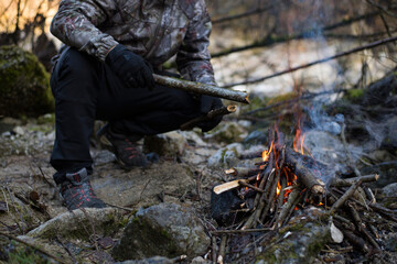 Lighting the fire at the campsite in winter.