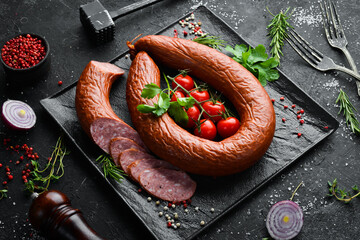 Smoked sausage ring with spices and herbs. Top view. Free space for text.