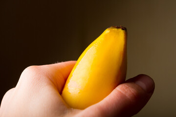 Woman hold tightly a banana