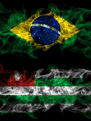 Brazil, Brazilian vs Abkhazia, Abkhzian smoky mystic flags placed side by side. Thick colored silky abstract smoke flags.