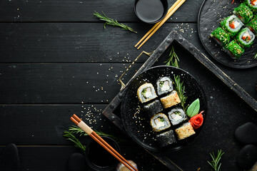 Traditional Sushi - Black and White, with crab, cheese and herbs. Japanese cuisine. Top view.