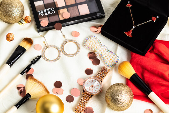 Christmas or new year eve background. Jewelry and makeup presents with neklace, makeup brush, earrings.