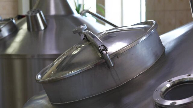 Large metal tanks for brewing beer in a beer factory
