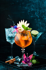Cocktail in a glass - Aperol spritz. on a black stone background. Menu bar. Alcohol.