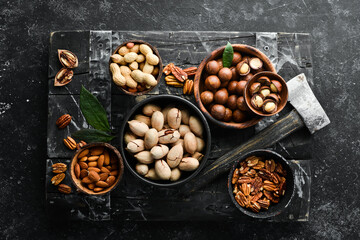 Obraz na płótnie Canvas Set of nuts. Macadamia nuts, pecans, peanuts and almonds. Top view.