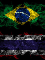 Brazil, Brazilian vs Thailand, Thai smoky mystic flags placed side by side. Thick colored silky abstract smoke flags.