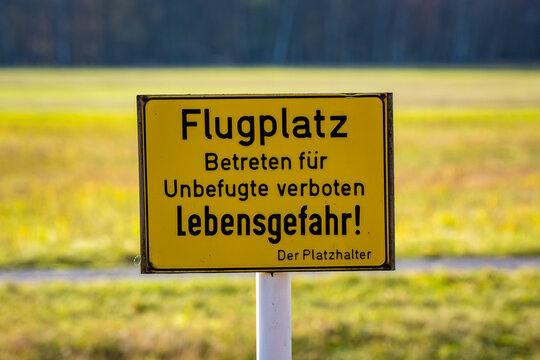 german warning sign. No entry to the airfield for unauthorized persons, danger to life! The placeholder. (In german language Flugplatz Betreten für Unbefugte verboten, Lebensgefahr! Der Platzhalter)