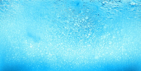 Fototapeta na wymiar Foam blue texture soap bubbles on the water abstract background