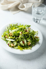 Healthy arugula salad with celery and walnut