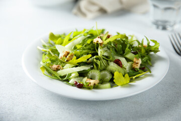 Healthy arugula salad with celery and walnut