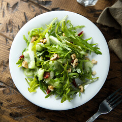 Healthy arugula salad with celery and walnut