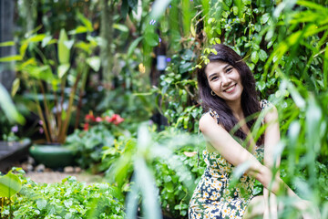 Beauty asian woman smiling with perfect smile and white teeth in a park and looking at camera