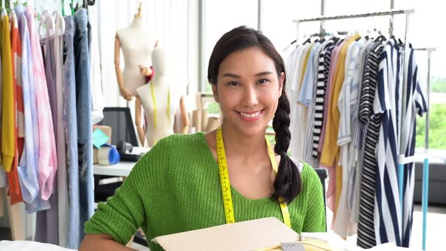 Young fashion designer smiling at camera