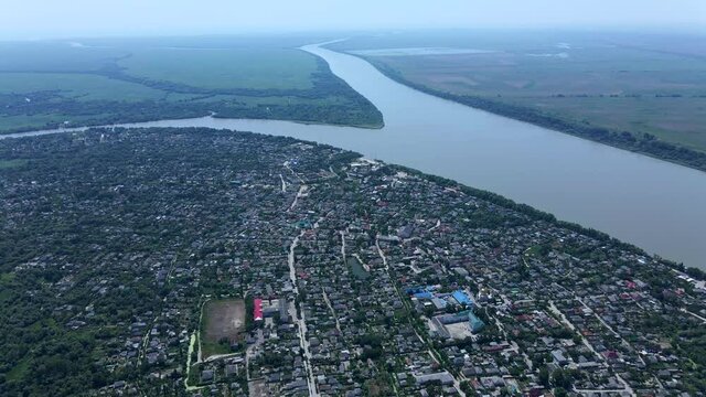 Aerial view on Vilkovo city (Ukrainian Venice, city built on water) on background is Ankudinov island. (4K-60fps) Vylkove, Danube river, Odessa oblast, Ukraine