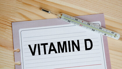 On a sheet from the diary text VITAMIN D, next to the thermometer.