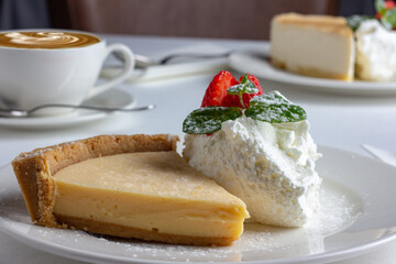 Slice of cake on white table.
Dessert and coffee