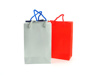 Paper shopping bags (grey, red, blue) isolated on white background, with space for your text..
