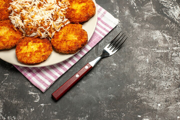 half-top view fried cutlets with cooked rice on dark background meat rissole dish