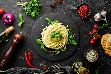 Pasta with pesto sauce, basil and pine nuts. Italian food. Top view.