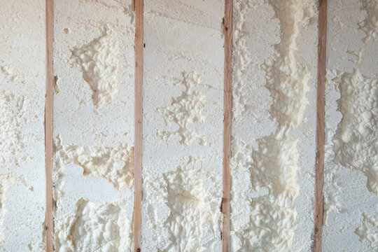 Freshly applied foam insulation in a basement wall