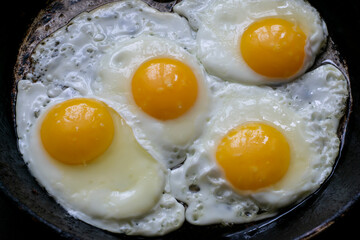 Fried chicken eggs in a pan. Close-up.