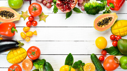 Set of fruits and vegetables on white wooden background. Food background. Top view. Free space for your text.