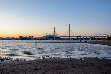 Fototapeta na wymiar Beautiful sunset in the Gulf of Finland. Zenith Arena and Cable-stayed Bridge.