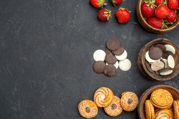 top view choco cookies with strawberries and biscuits on a dark background fruit sweet biscuit
