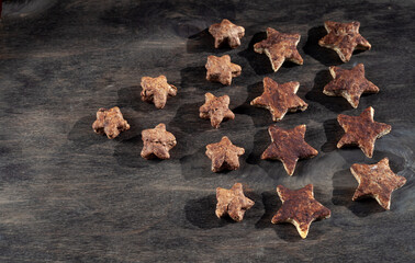 Homemade chocolate cookies in the shape of stars. Baking on a wooden background. Simple cooking at home. Star cookie.