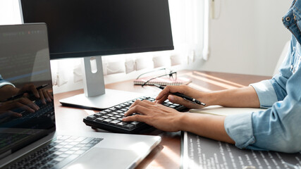 Fototapeta premium Software developer or programmer working data debugging improvement binary algorithm on desktop pc in a software develop company office.