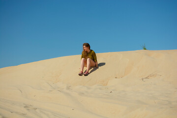 Positive and active young woman silhouette walking near the sea beach. Resort vacation. A person's activities beautiful portrait.