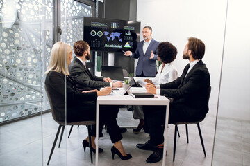 Business concept. Successful confident experienced diverse team of corporative workers, listening...
