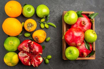 top view fresh pomegranates with apples and other fruits on dark background ripe fruit color