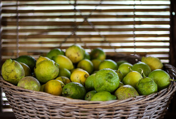 Lemons/Lime in a wooden basket/container