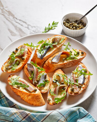 anchovy butter sandwiches with capers and arugula