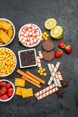 top view fresh strawberries with different snacks on a dark background fruit biscuit sweet