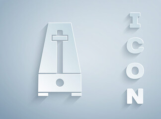 Paper cut Classic Metronome with pendulum in motion icon isolated on grey background. Equipment of music and beat mechanism. Paper art style. Vector.