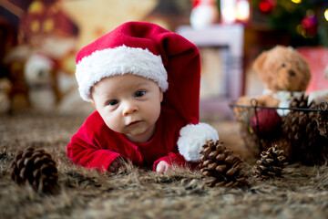 Portrait of newborn baby in Santa clothes in little baby bed
