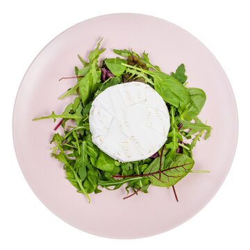 Top View Of Soft Cheese On Fresh Greens On Pink Plate Isolated On White Background