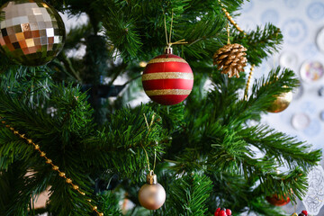 The golden balls adorn the Christmas tree beautifully.