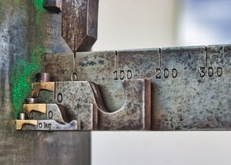 Detail of an old measuring instrument with scale on a village square in Germany