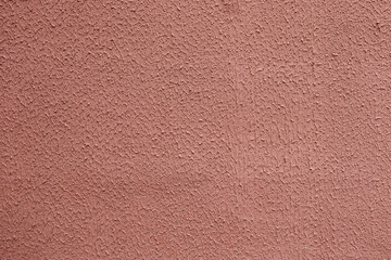 Pale grained red background texture on the wall