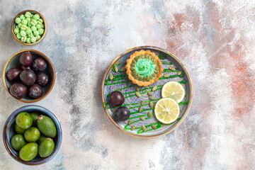 top view little cake with fruits and candies on light desk sweet dessert biscuit