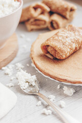 pancakes with curd filling and black currants on a plate