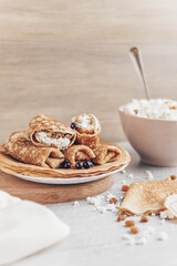 Fototapeta na wymiar cottage cheese in a bowl and pancakes with curd filling