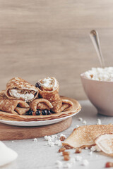 cottage cheese in a bowl and pancakes with curd filling